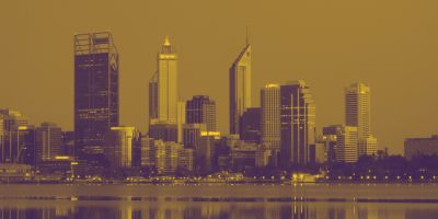A city skyline with several skyscrapers reflecting on a body of water